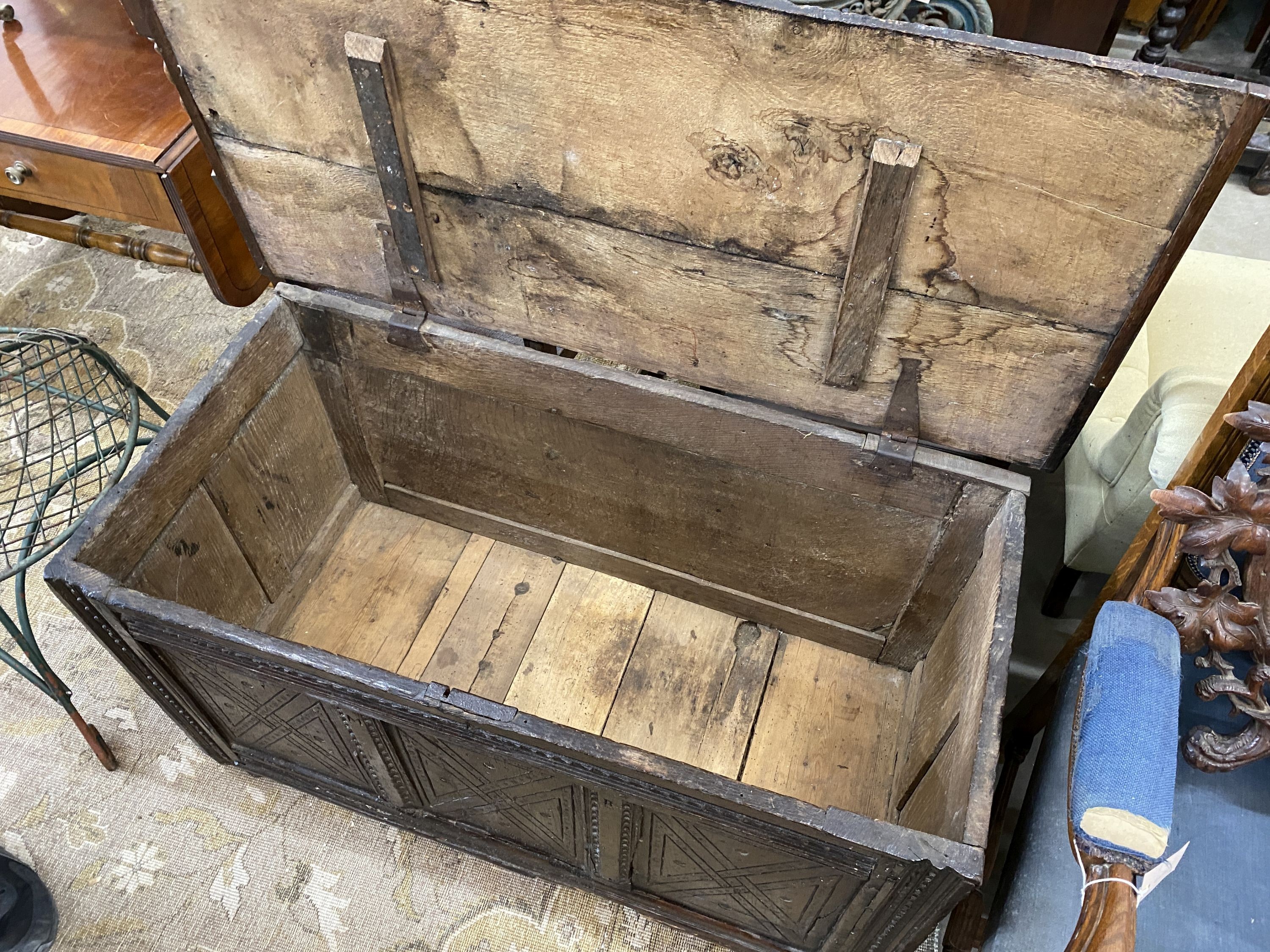 A 17th century carved oak coffer, length 110cm, depth 52cm, height 61cm